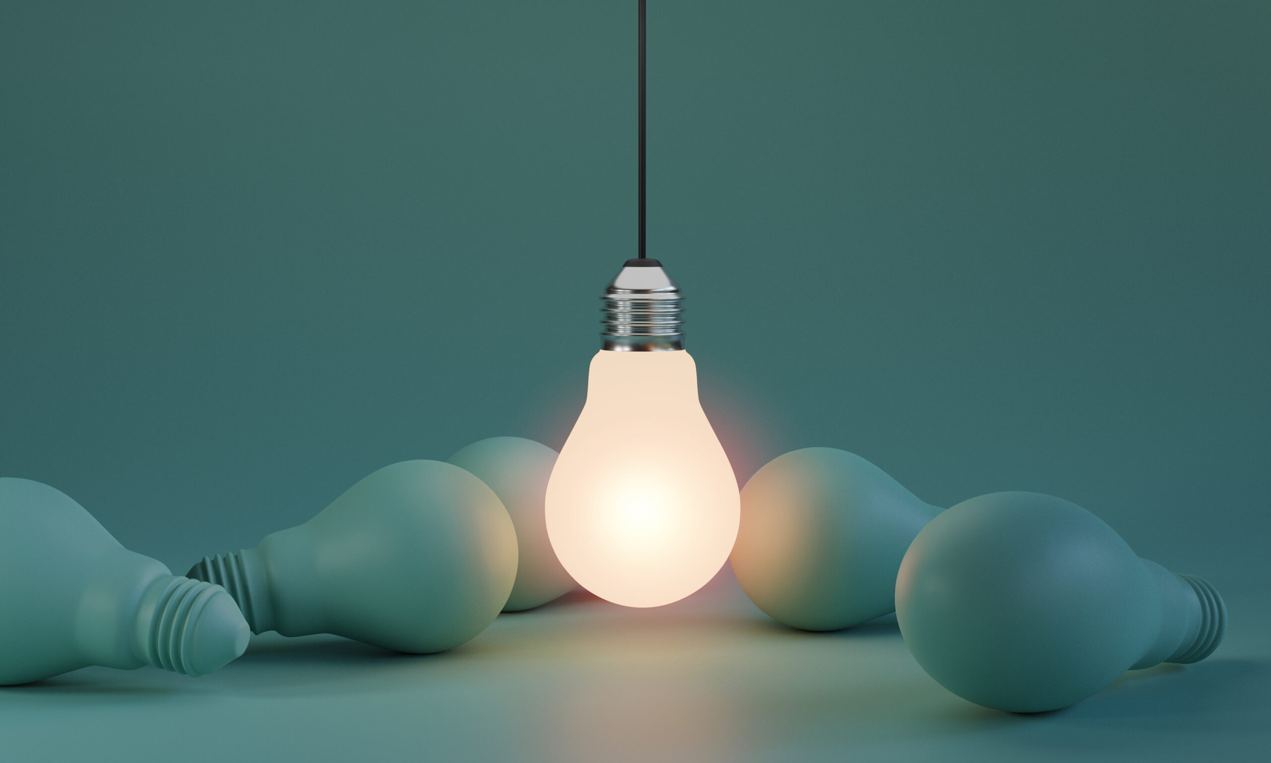 One of Lightbulb glowing among shutdown light bulb in dark area
